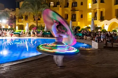 a person is standing in front of a swimming pool at Three Corners Rihana Resort El Gouna in Hurghada