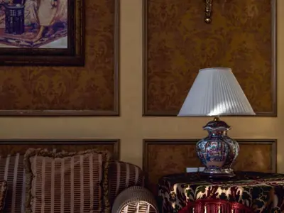 a lamp sitting on a table next to a chair at Sofitel Winter Palace Luxor in Luxor
