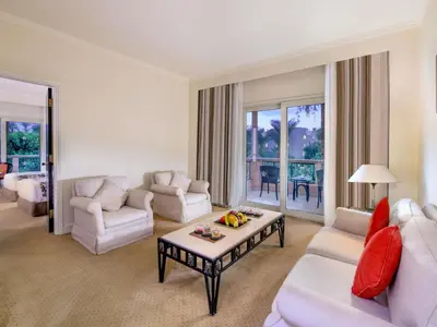 a living room with a white couch and a table at Pavillon Winter Luxor in Luxor