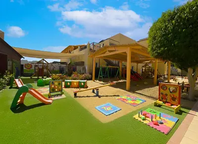 a backyard with a playground with a slide and play equipment at Casa Mare Resort - ex, Royal Tulip Beach Resort in Port Ghalib