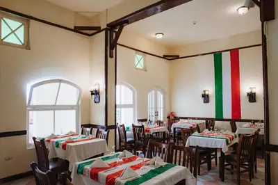 a restaurant with tables and chairs with red and green stripes at Empire Hotel Aqua Park in Hurghada