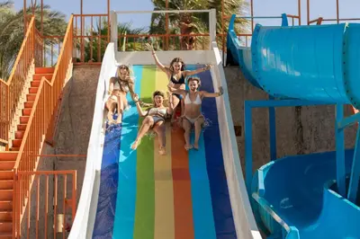 a group of children on a water slide at a water park at Empire Beach Aqua Park in Hurghada
