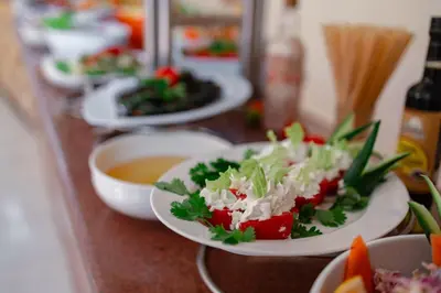 a group of plates of food on a counter at Empire Beach Aqua Park in Hurghada