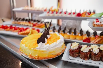 a bunch of desserts and pastries on a buffet at Empire Beach Aqua Park in Hurghada