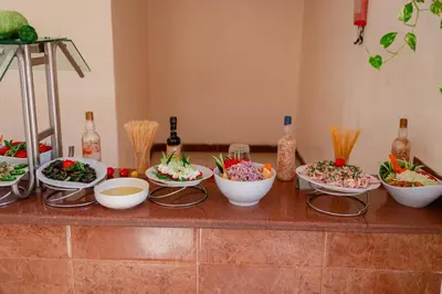 a group of bowls of food on a counter at Empire Beach Aqua Park in Hurghada