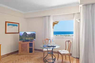 a room with a table and chairs and a window at The Cascades Golf Resort, Spa & Thalasso in Hurghada