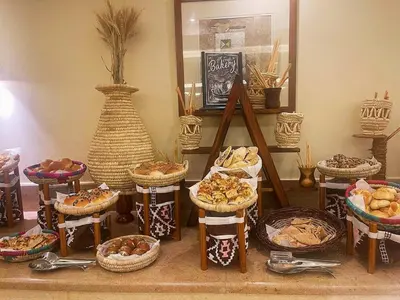 a display of different types of bread and pastries in baskets at Steigenberger Resort Achti in Luxor
