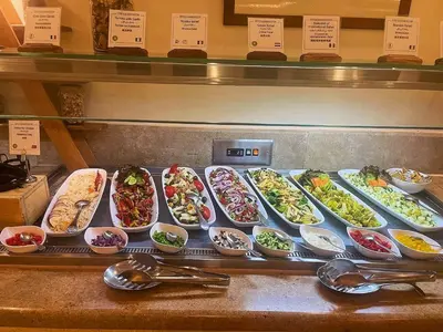a display case with many different dishes of food at Steigenberger Resort Achti in Luxor