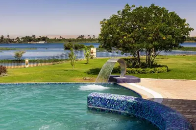 a fountain in the middle of a swimming pool at Jolie Ville Hotel & Spa Kings Island Luxor in Luxor