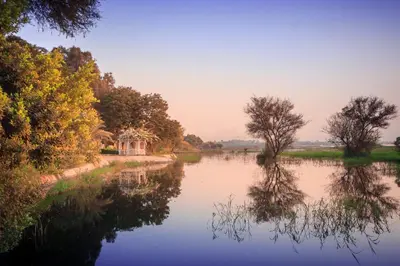 a river with trees and a house in the distance at Jolie Ville Hotel & Spa Kings Island Luxor in Luxor