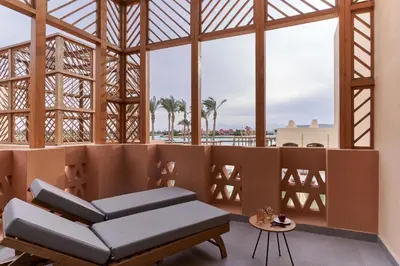 a room with a couch and a large window at Steigenberger Golf Resort El Gouna in Hurghada