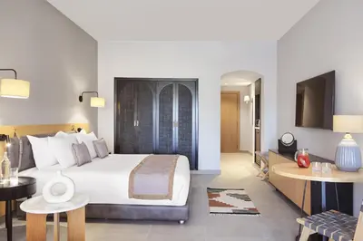 a hotel room with a bed and a desk at Steigenberger Golf Resort El Gouna in Hurghada