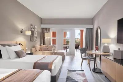 a hotel room with two beds and a living room at Steigenberger Golf Resort El Gouna in Hurghada