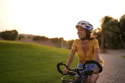 a young woman riding a bike down a sidewalk at Steigenberger Golf Resort El Gouna in Hurghada