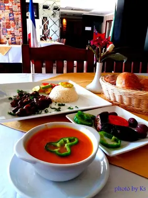 a bowl of soup and a plate of food on a table at Elaria Hotel Hurgada in Hurghada