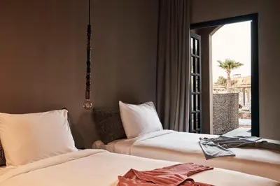 a hotel room with two beds and a window at Cook’s Club El Gouna (Adults Only) in Hurghada