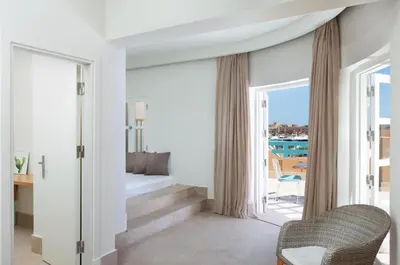 a living room with a staircase leading to a balcony at Captain's Inn Hotel in Hurghada