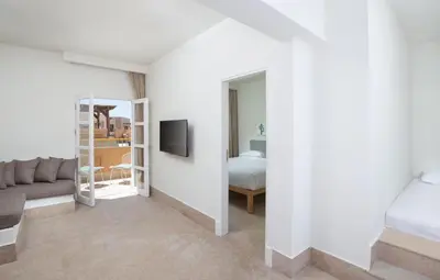 a white room with a bed and a couch at Captain's Inn Hotel in Hurghada