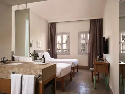 a hotel room with a bed and a sink at Captain's Inn Hotel in Hurghada