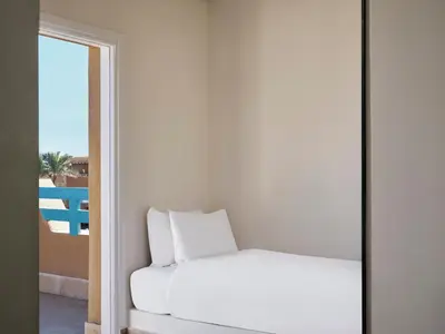 a bedroom with a bed and a view of a balcony at Captain's Inn Hotel in Hurghada