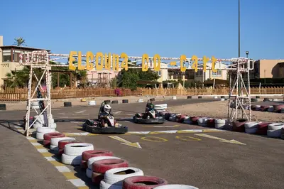two people riding on motorcycles in a race track at Ali Pasha Hotel in Hurghada