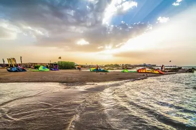 a group of people on a beach with kites at Ali Pasha Hotel in Hurghada