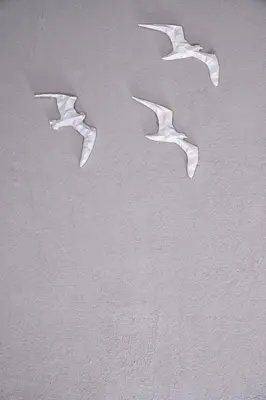 three pieces of paper on a white wall at Turtle's Inn Hotel in Hurghada
