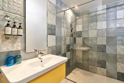 a bathroom with a sink and a shower at Turtle's Inn Hotel in Hurghada