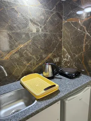 a yellow tray sitting on top of a kitchen sink at Mini-Studio With Free Private Beach in Hurghada
