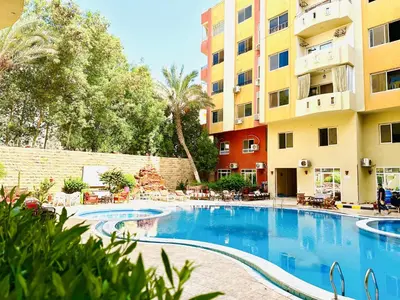a swimming pool in front of a building at Diamond Arabia Orange in Hurghada