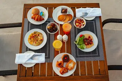 a table with plates of breakfast food on it at Hurghada Marriott Beach Resort in Hurghada