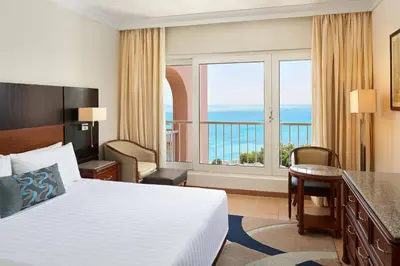 a hotel room with a bed and a view of the ocean at Hurghada Marriott Beach Resort in Hurghada