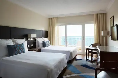 a hotel room with two beds and a balcony at Hurghada Marriott Beach Resort in Hurghada
