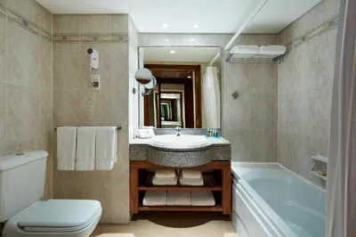 a bathroom with a sink and a tub and a toilet at Hurghada Marriott Beach Resort in Hurghada