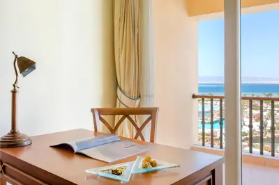 a desk with a lamp and a plate of food on it at Kempinski Hotel Soma Bay in Hurghada