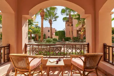 a patio with two chairs and a table on a balcony at Hotel Sultan Bey Resort in Hurghada