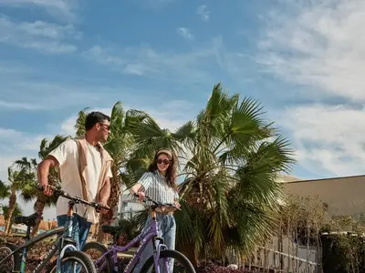 a man and a woman standing with their bikes at Hotel Sultan Bey Resort in Hurghada