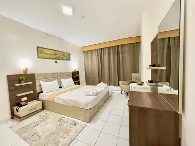 a hotel room with a bed and a desk at Gaddis Hotel, Suites and Apartments in Luxor