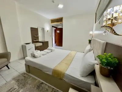 a bedroom with a large bed with white sheets and pillows at Gaddis Hotel, Suites and Apartments in Luxor