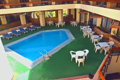 an overhead view of a pool with tables and chairs at Gaddis Hotel, Suites and Apartments in Luxor