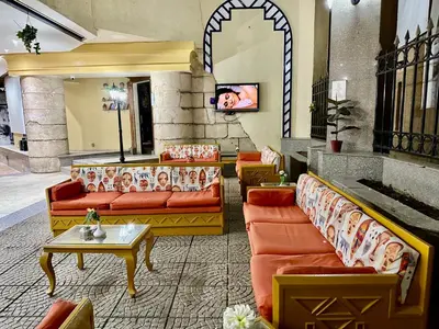 a lobby with couches and a tv in a building at Gaddis Hotel, Suites and Apartments in Luxor