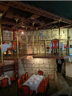 a restaurant with tables and chairs in a room at Gaddis Hotel, Suites and Apartments in Luxor