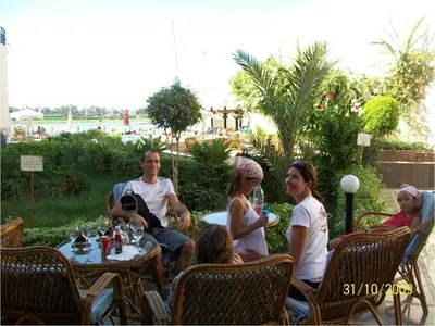 a group of people sitting around a table at Lotus Luxor Hotel in Luxor
