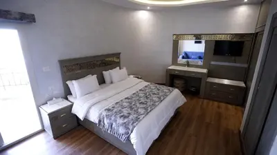 a bedroom with a bed and a sink and a mirror at Lotus Luxor Hotel in Luxor