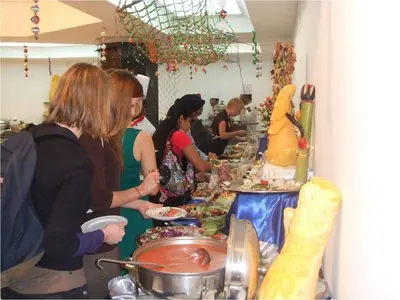 a group of people standing around a buffet line with food at Lotus Luxor Hotel in Luxor