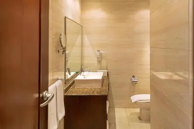 a bathroom with a sink and a toilet at Sunny Days Mirette Family Resort in Hurghada