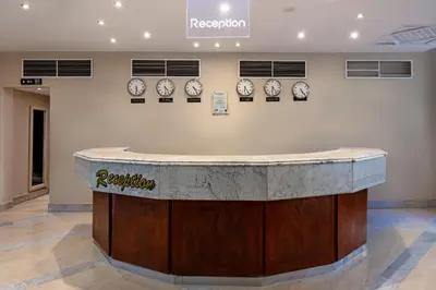 a counter in a room with clocks on the wall at Sunny Days Mirette Family Resort in Hurghada