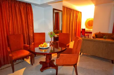 a living room with a table and chairs and a couch at Aracan Eatabe Luxor Hotel in Luxor