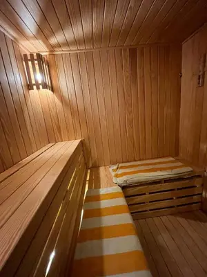 a small wooden sauna with a bed and a rug at Aracan Eatabe Luxor Hotel in Luxor