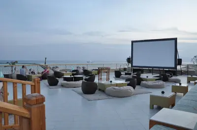 a flat screen tv sitting on a patio near the beach at The Breakers Diving and Surfing Lodge Soma Bay in Hurghada